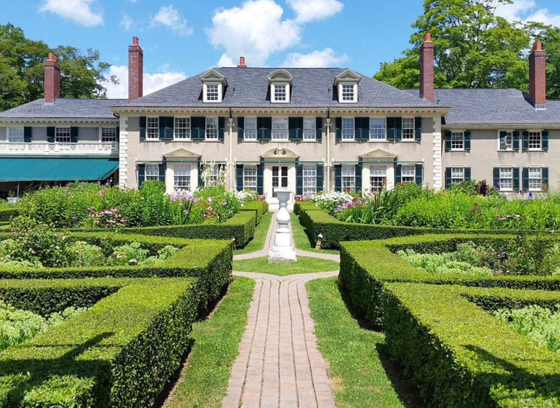 a large house with gardens in front - high net worth insurance